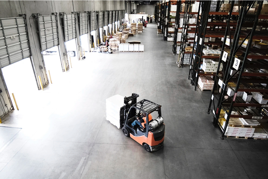 forklift moving goods in warehouse